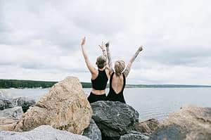 women sitting on a rock