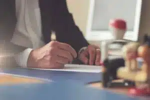 man writing on a piece of paper