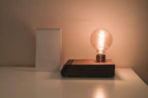 lightbulb and notebook on desk