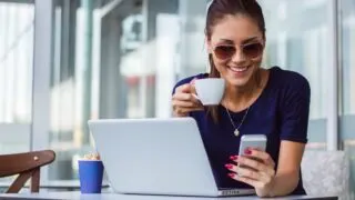 Happy Woman with mobile and coffee
